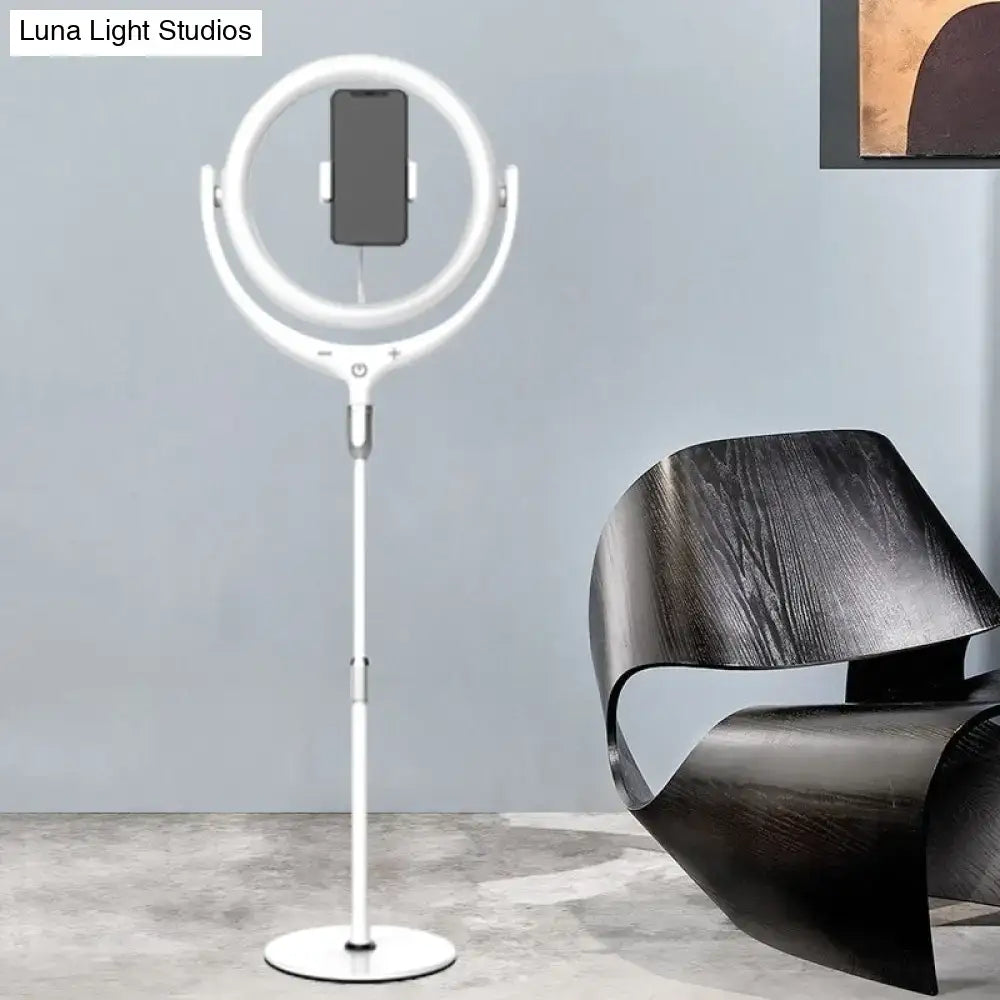Modern black and white led mirror lamp featuring a white ring light with adjustable stand and phone holder for bedroom use