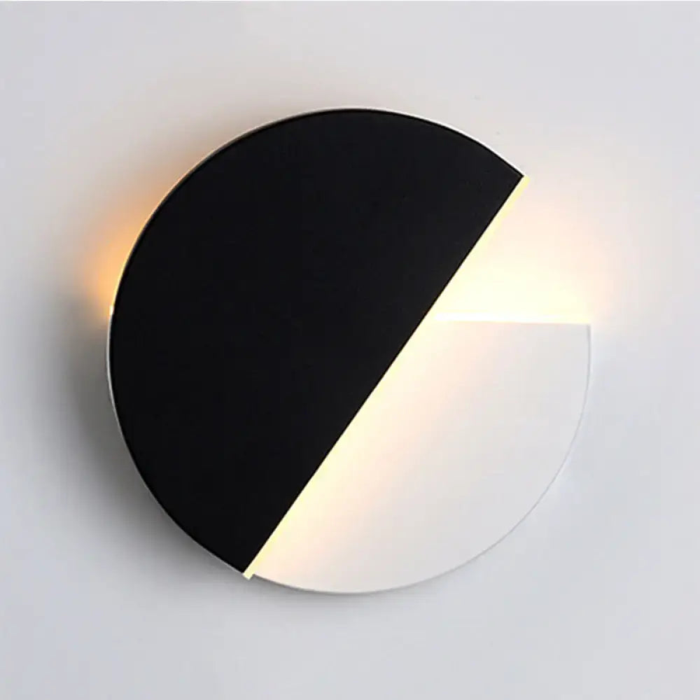 Modern black and white rotatable acrylic wall lamp with minimalist circular design for bedroom use