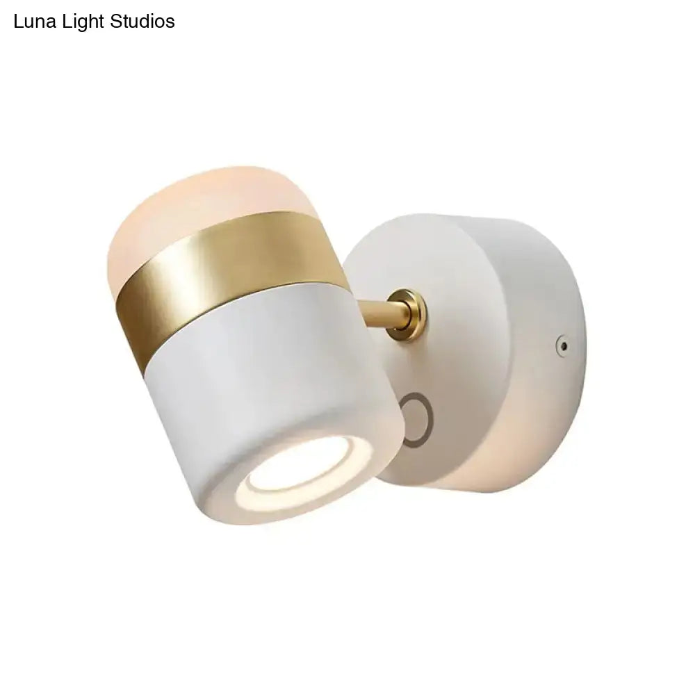 Modern black and white rotatable led spotlight with frosted glass shade, gold band, and brass hardware bedroom wall sconce