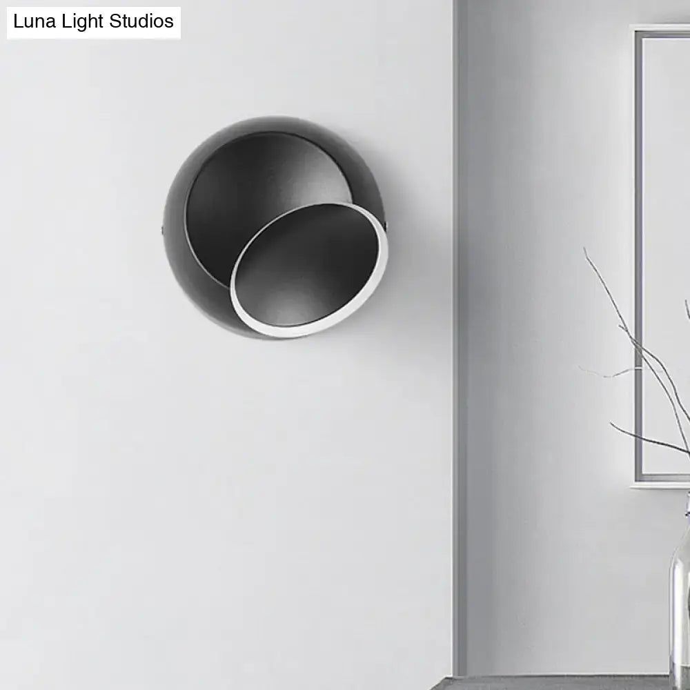 Modern black and white rotating eclipse wall lamp with circular minimalist design LED bedroom sconce