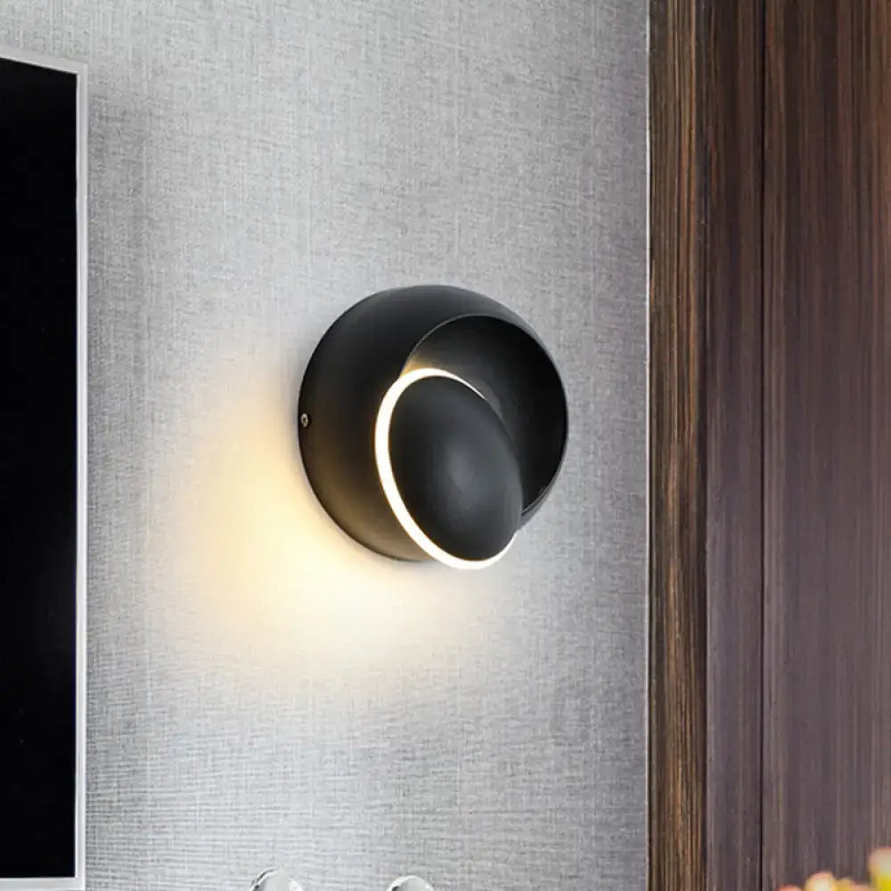 Modern black and white rotating eclipse wall lamp with sleek circular led sconce and illuminated ring accent for bedroom