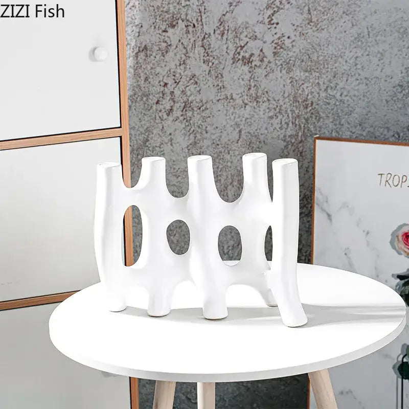 Modern black and white decorbites ceramic vase with abstract organic design and circular cutouts for living room decor