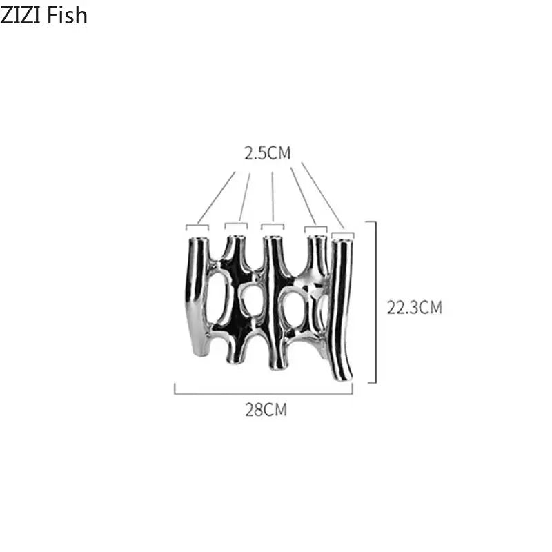 Modern black and white decorbites ceramic vase shaped like a shiny metallic fish with intricate cut-out patterns for living room decor