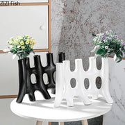 Modern black and white ceramic vase with sculptural tree like design and oval cutouts decorbites ceramic vase decor