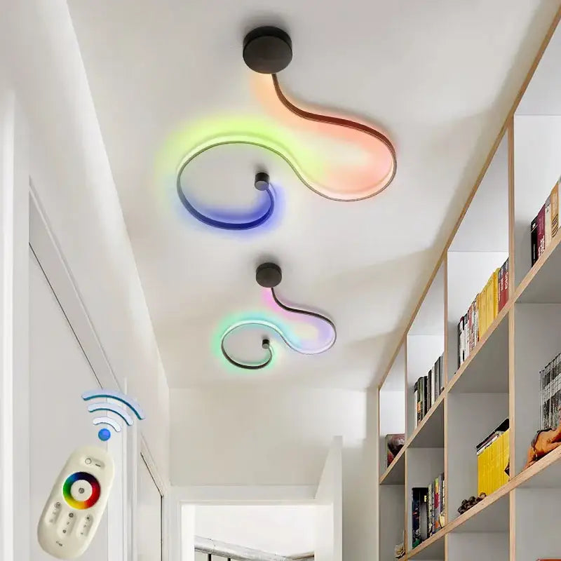 Two modern black wall lamps with curved acrylic bodies emit vibrant rainbow light for contemporary bedroom decorbites decor