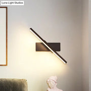 Modern black and white slim led wall sconce with a sleek angled led light bar for bedroom linear lighting