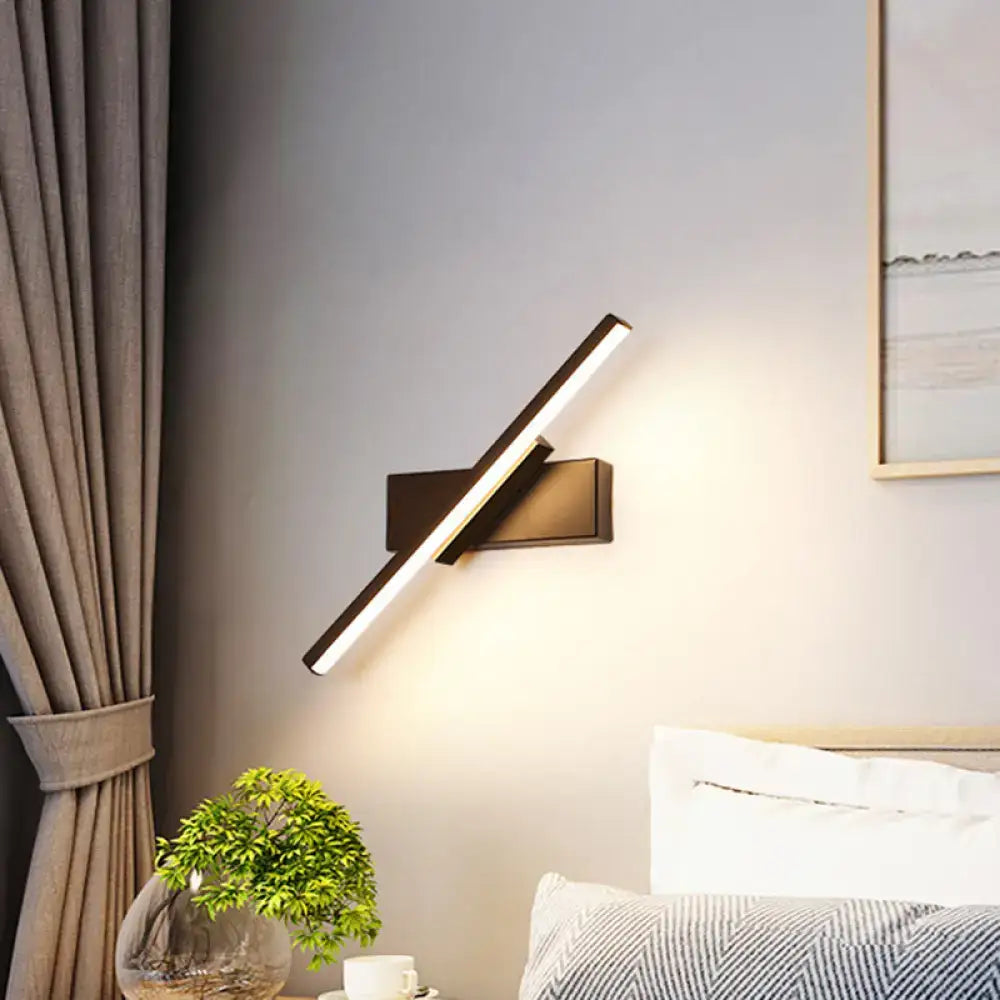 Modern black and white slim led wall sconce with sleek angular design and warm white illumination for bedroom lighting