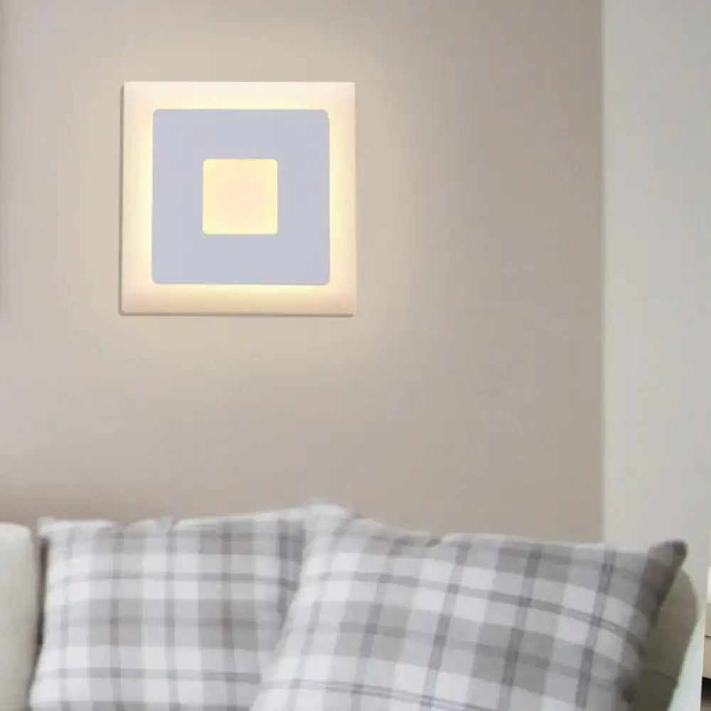 Modern black and white square wall sconce lamp with layered beige frame and warm yellow illumination for bedroom use