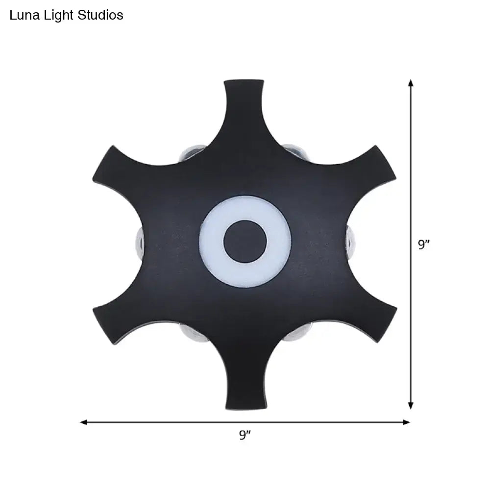 Modern black 9-inch star shaped led wall light fixture with central white accent and warm white light for bedroom use