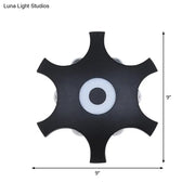 Modern black 9-inch star shaped led wall light fixture with central white accent and warm white light for bedroom use