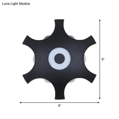 Modern black 9-inch star shaped led wall light fixture with central white accent and warm white light for bedroom use