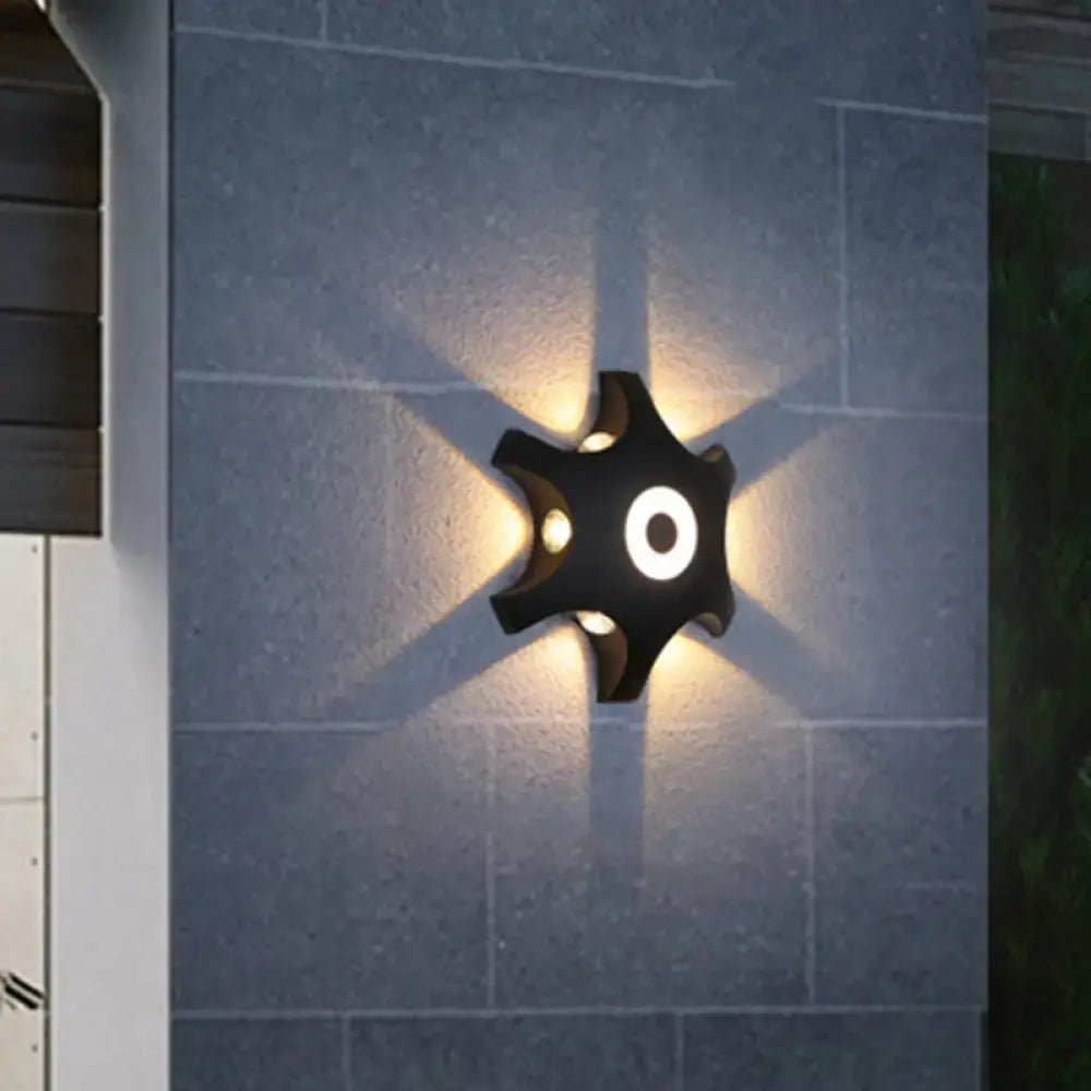 Modern black star led wall light with four warm white light LEDs radiating from a central circular design for bedroom use