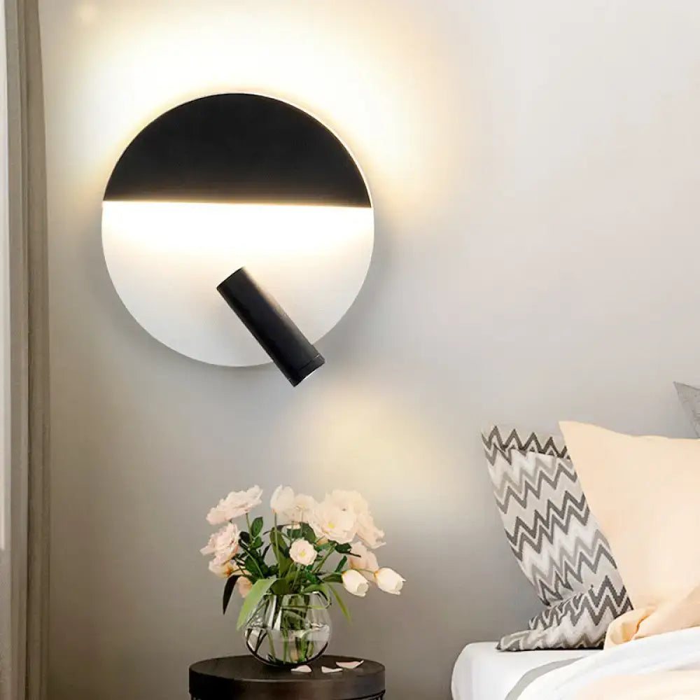 Modern black and white wall sconce with adjustable spotlight featuring a sleek minimalist design for bedroom lighting