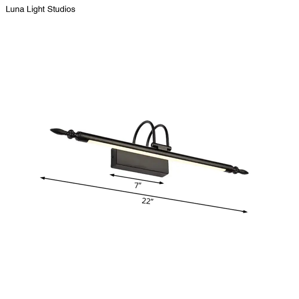 Black wrought iron vanity lighting with decorative spear tips featuring white warm light for bathroom use
