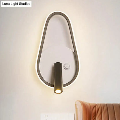 Modern teardrop-shaped black and white wall light with a sleek metallic frame and white warm light for bedroom use