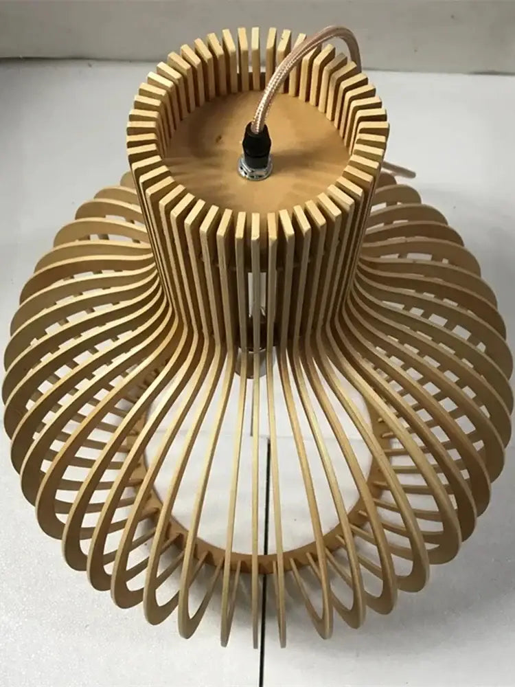 A modern light brown wooden pendant light with curved slats designed as a white wood cage for living room use