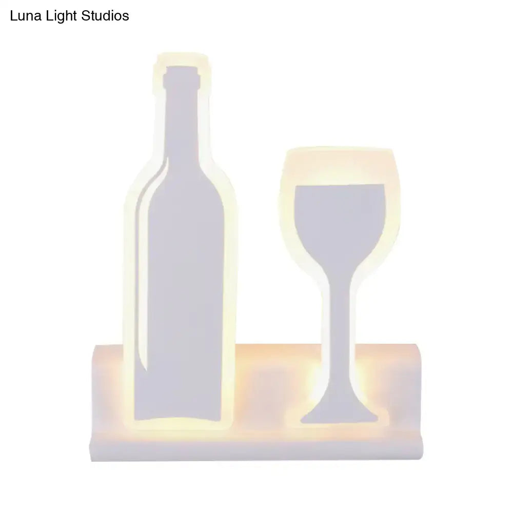 Modern black wine sconce light with warmly glowing led wine bottle and glass sculpture on wooden base fixture height
