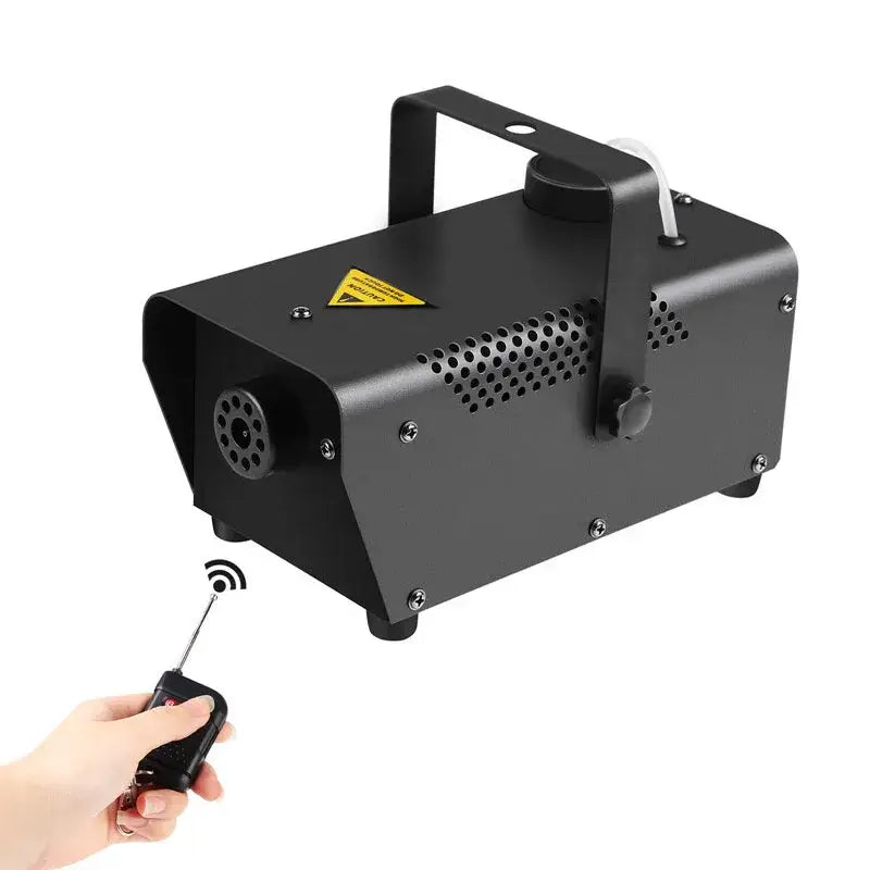 Black metal wireless fog machine pump with perforated side panels and handle shown with remote control for living room party stage