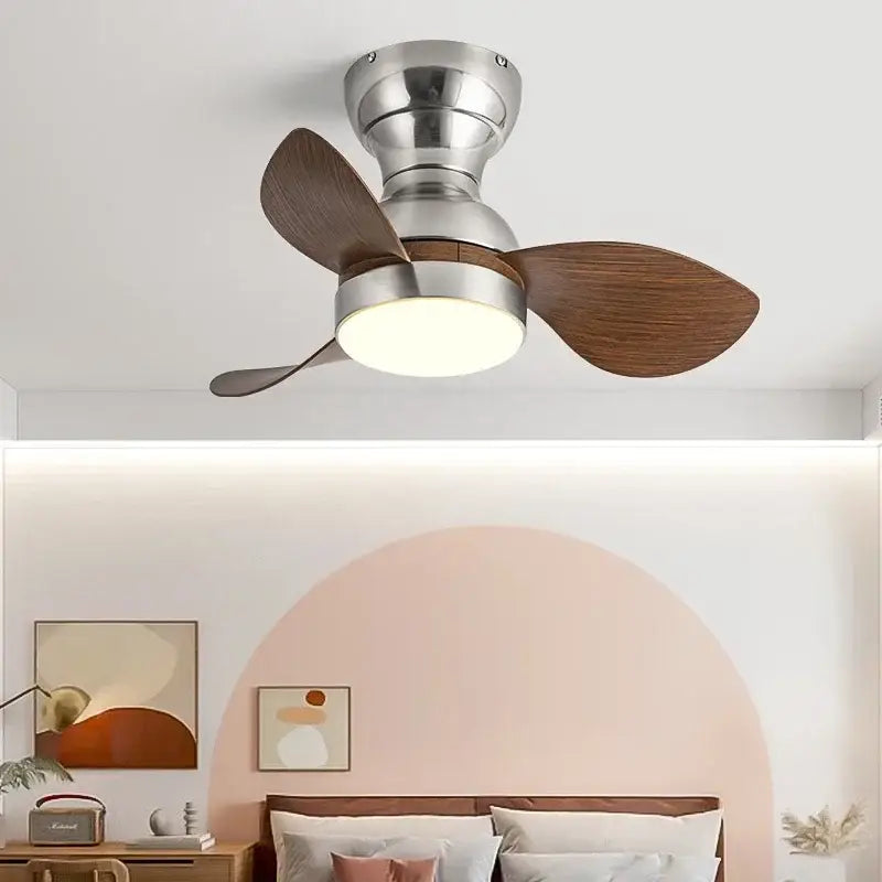Stylish modern black ceiling fan with dark wood blades silver metallic housing and integrated led lighting for bedroom use
