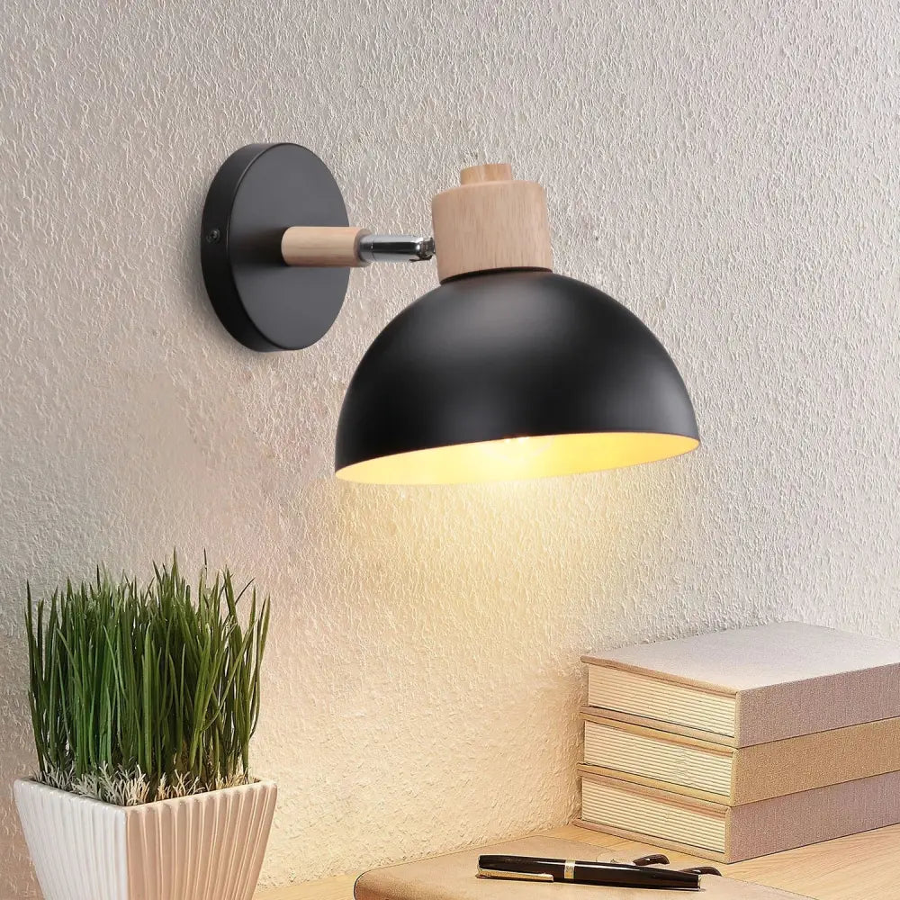 Modern black wooden wall light with black matte finish, wooden accent, and adjustable arm casting warm light by decorbites black wooden
