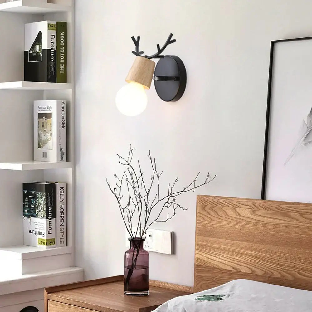 Modern black wooden wall light with antler design and warm glowing bulb perfect for living room decorbites black wooden wall sconce