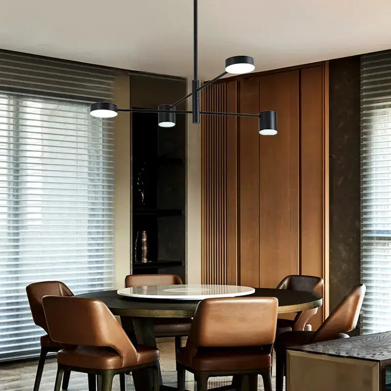 Modern black wrought iron chandelier with three circular bulbs and sleek metal arms for living room lighting