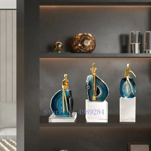 Three elegant blue agate crystal golden sculptures with gold-toned figurines on clear acrylic bases for decorbites agate crystal living room decor