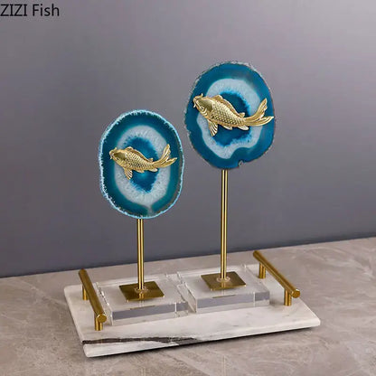 Elegant golden fish ornaments on vibrant blue agate slices with a marble base and brass stands for decorbites blue agate decor