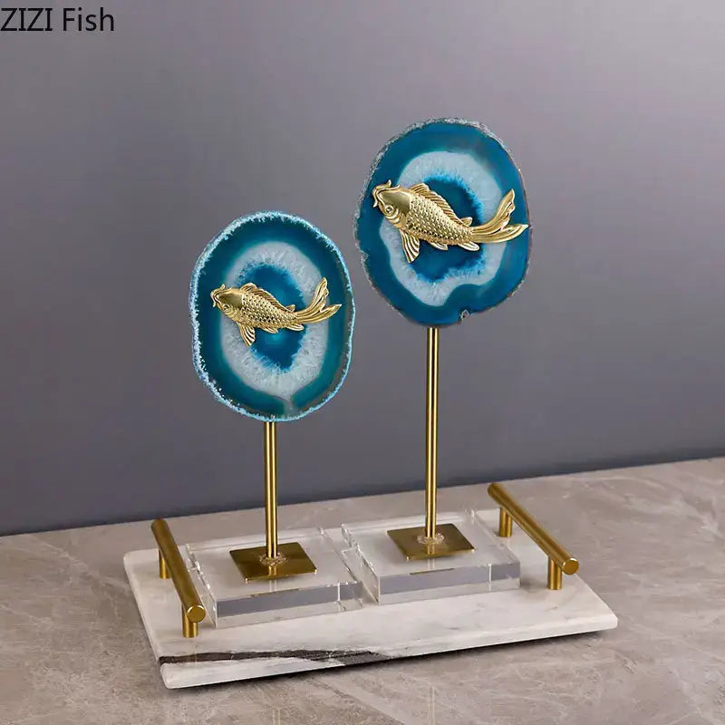 Elegant golden fish ornaments on vibrant blue agate slices with a marble base and brass stands for decorbites blue agate decor