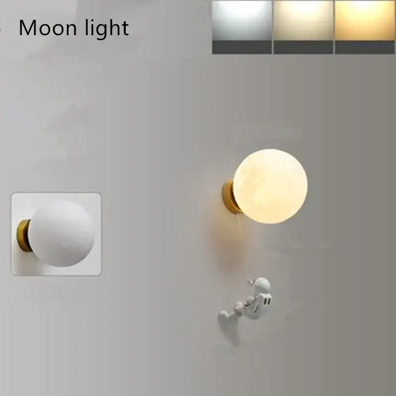 Modern blue astronaut moon wall lamp with warm glow, matte finish, and gold-toned mounting base by decorbites astronaut moon