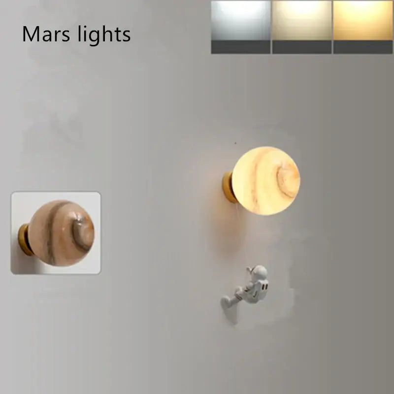 Modern blue astronaut moon wall lamp with warm-toned marbled wood finish and brass base by decorbites astronaut moon