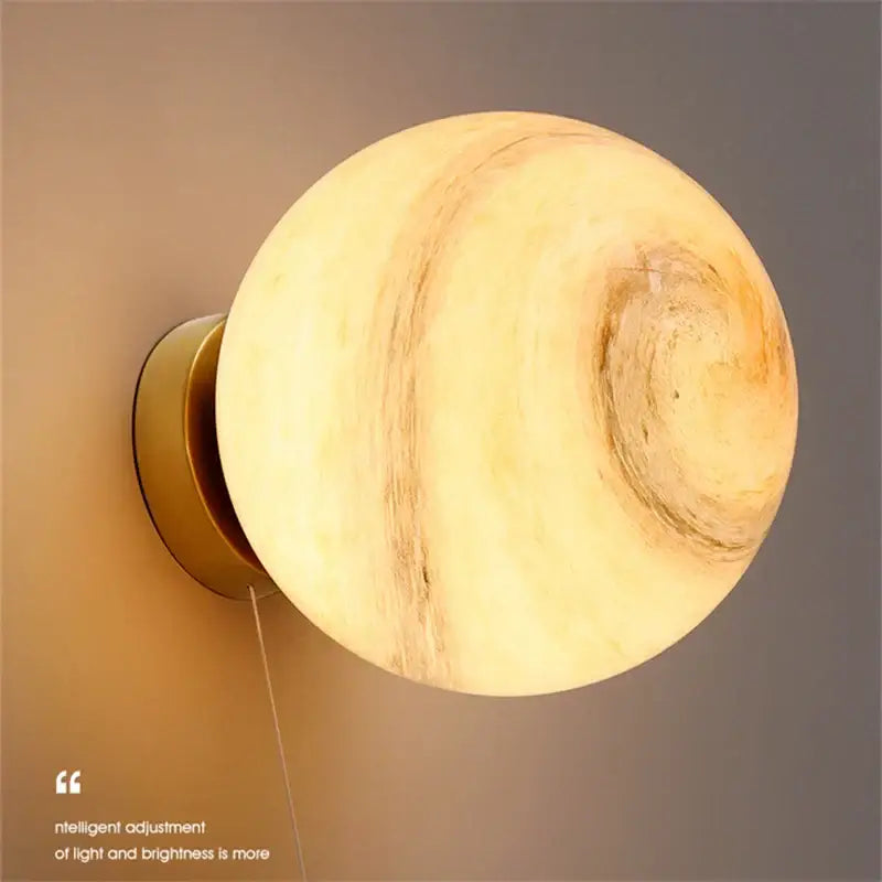 Warm-toned spherical wall lamp with swirling marble texture and brass base for decorbites astronaut moon bedroom light