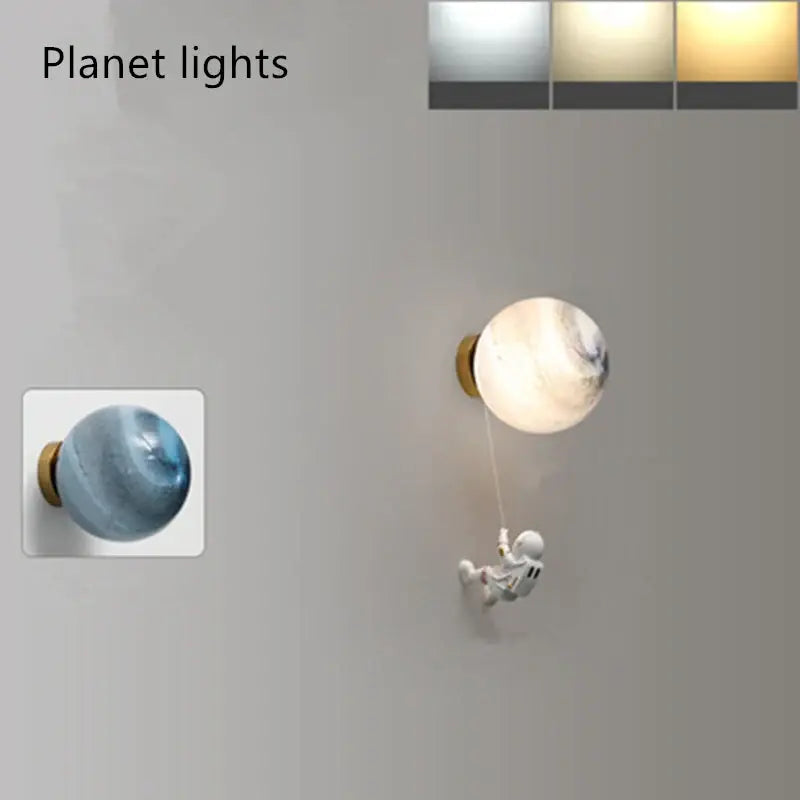 Modern blue astronaut moon wall lamp featuring a translucent marbled globe with gold base and decorbites astronaut moon figurine
