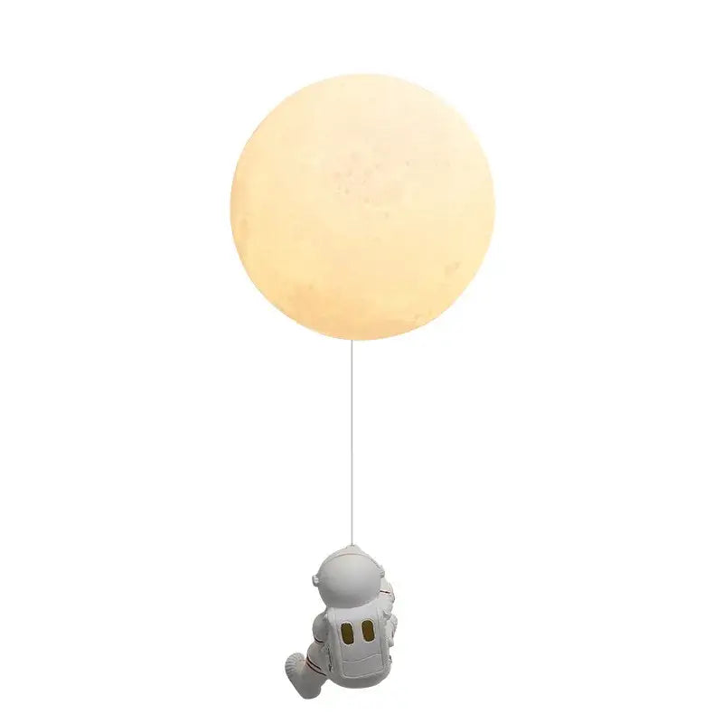 A white astronaut figurine hanging from a glowing textured moon shaped wall lamp modern blue astronaut moon decorbites astronaut moon