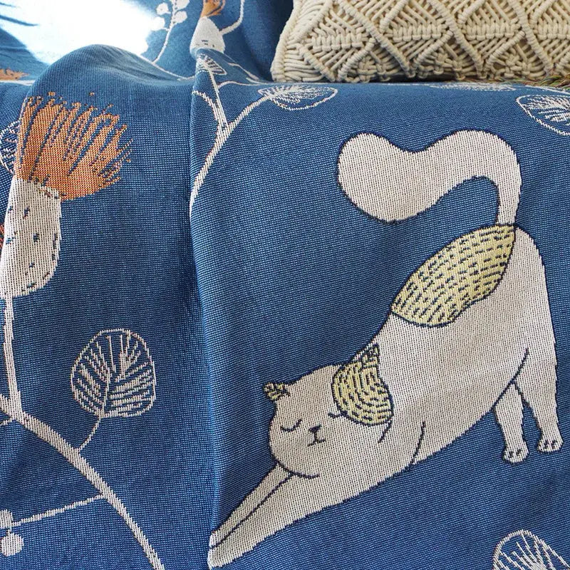 Modern blue cartoon cat woven blanket featuring a white cat with yellow-tipped ears and stylized plants for decorbites cartoon cat decorbites cartoon decor