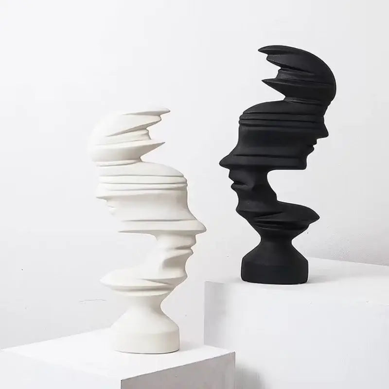 Elegant abstract human face sculptures in matte white and black with layered spiraling contours for decorbites abstract human face living room decor