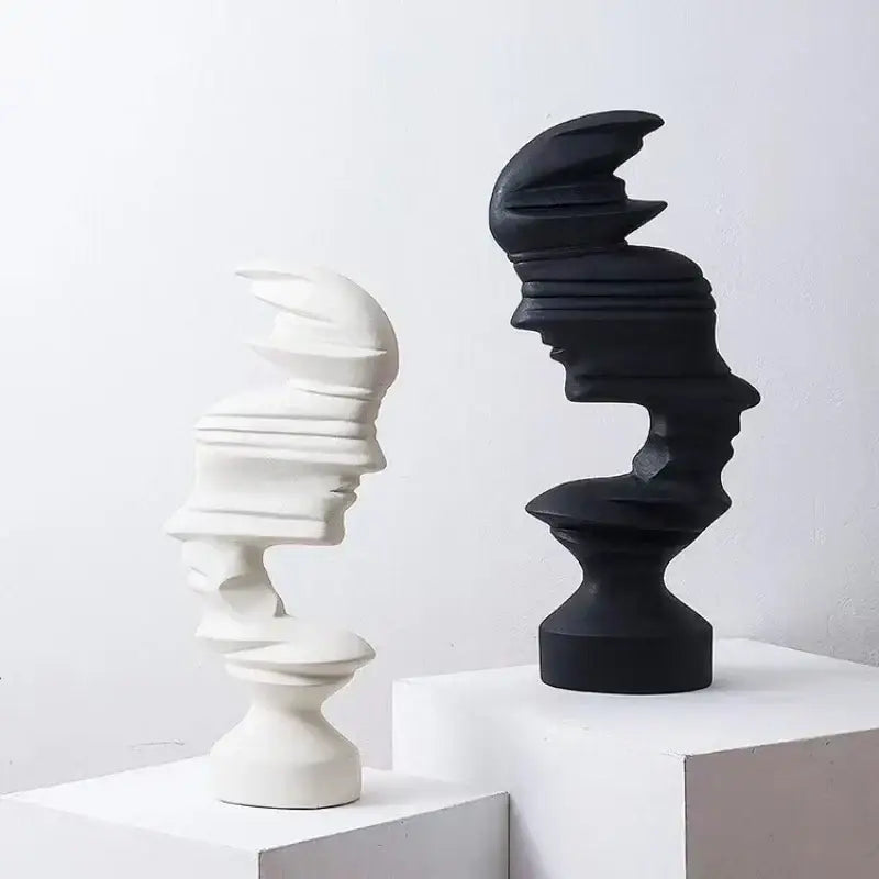 Two abstract human face sculptures in matte white and glossy black ceramic for modern living room decorbites decor