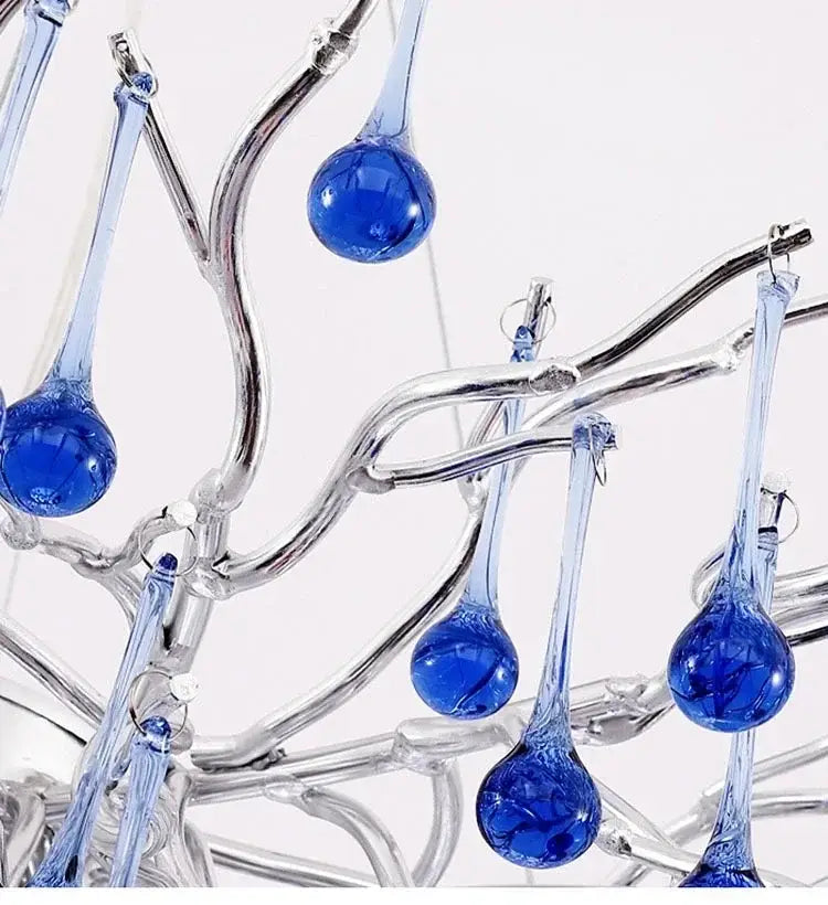 Modern blue chrome crystal chandelier featuring blue glass teardrop pendants on a silver branch design decorbites chrome crystal