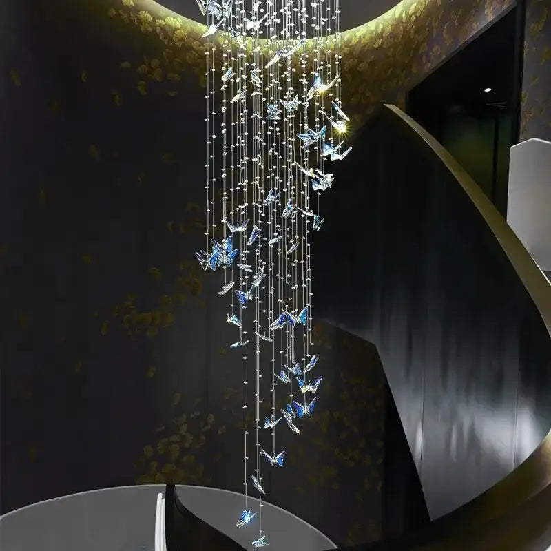 Elegant decorbites butterfly crystal chandelier with cascading clear and blue butterfly ornaments on golden fixture