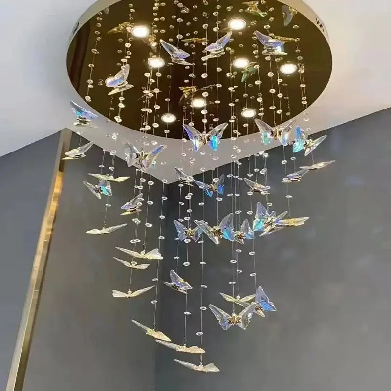 Modern blue and clear butterfly crystal chandelier by decorbites with iridescent crystals and gold-toned frame for staircase lighting