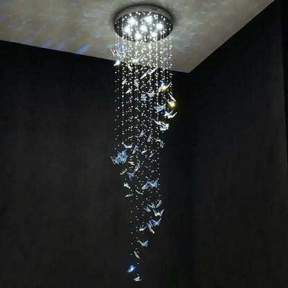 Modern blue and clear butterfly crystal chandelier by decorbites with cascading crystals and bright white lights for staircase decor