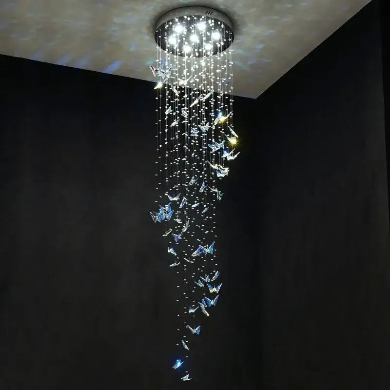 Modern blue and clear butterfly crystal chandelier by decorbites with cascading crystals and bright white lights for staircase decor