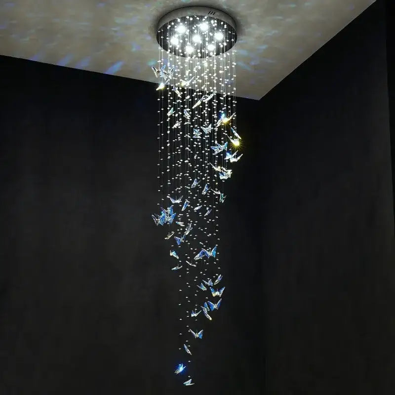 Modern blue and clear crystal butterfly rotating chandelier with cascading strings and glowing decorbites crystal butterfly ornaments