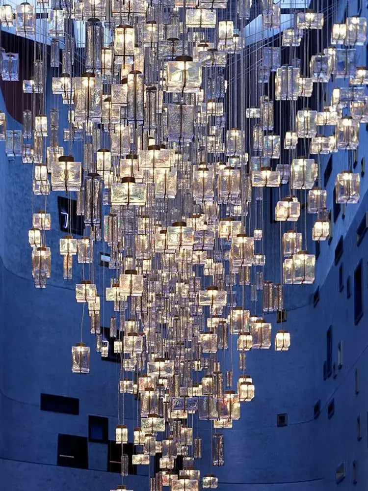 Modern blue and clear crystal cube pendant light featuring cascading translucent glass cubes with warm lights