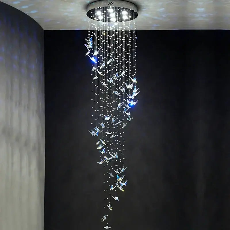 Modern blue and clear crystal staircase chandelier with circular mount and cascading butterfly strands by decorbites crystal