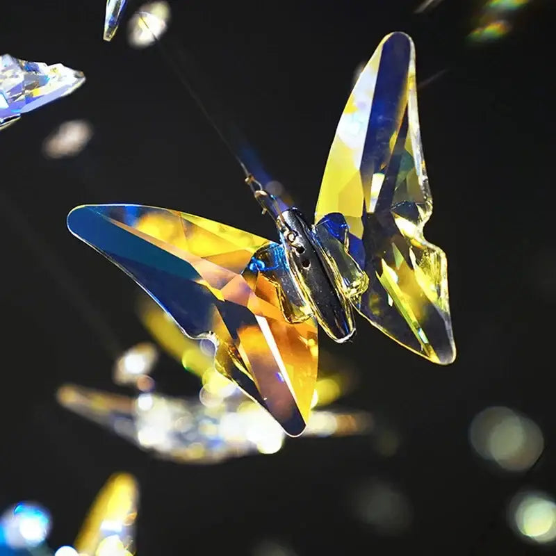 A sparkling yellow and blue crystal butterfly ornament with faceted wings for decorbites crystal staircase chandelier