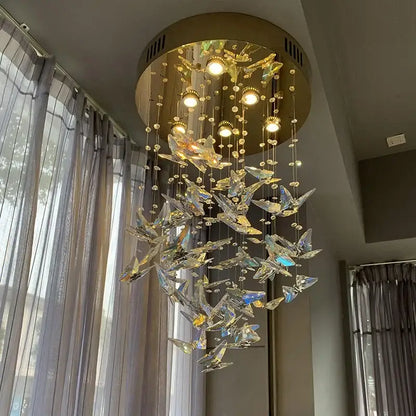 Modern blue and clear decorbites crystal staircase chandelier with golden circular frame and crystal butterfly accents