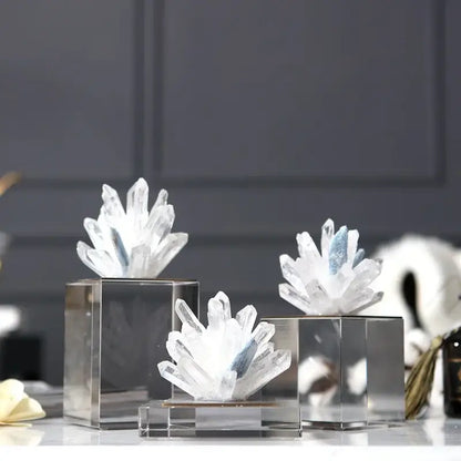 Modern blue crystal flower marble base sculpture features clear quartz clusters with subtle blue inclusions on sleek bases