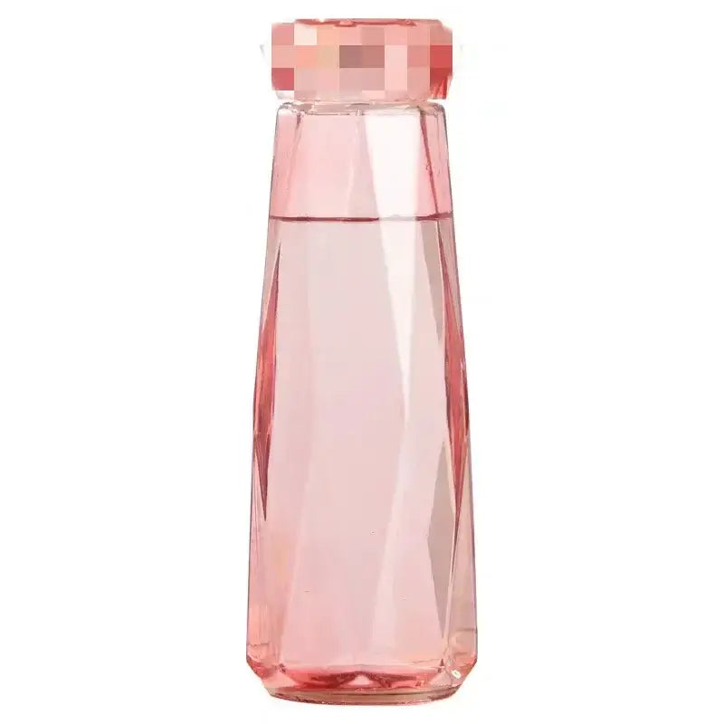 Modern blue diamond water bottle in translucent pink faceted glass with geometric cap for kitchen and sport travel