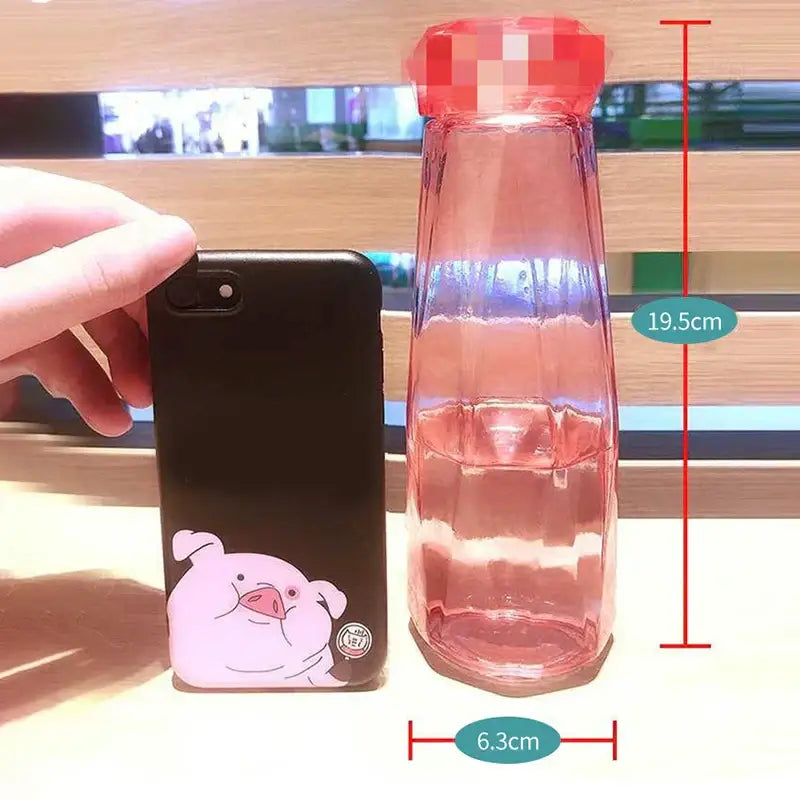 Modern translucent pink faceted glass diamond water bottle with red pixelated cap for kitchen and sport travel